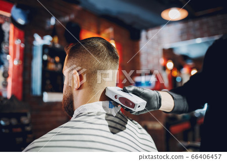 Stylish man sitting in a barbershop 66406457