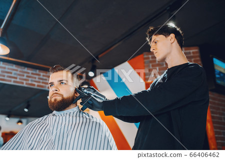 Stylish man sitting in a barbershop Stylish man sitting in a barbershop 66406462
