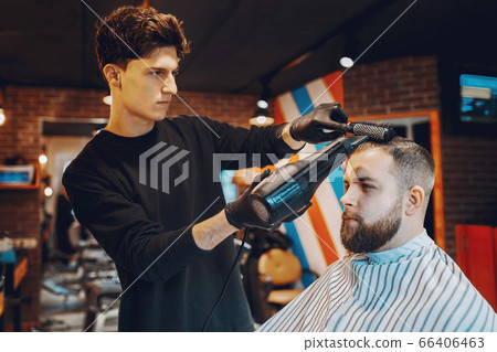 Stylish man sitting in a barbershop Stylish man sitting in a barbershop 66406463