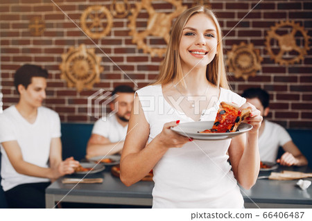Cute friends in a cafe eatting a pizza 66406487