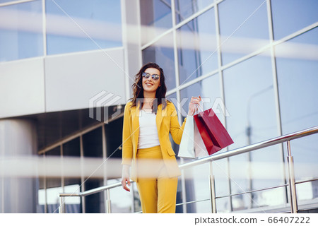 Cute girl with shopping bag in a city Cute girl with shopping bag in a city 66407222