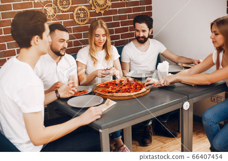 Cute friends in a cafe eatting a pizza 66407454