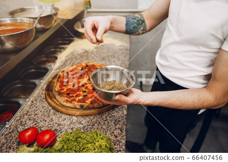 Chef in the kitchen prepares pizza Chef in the kitchen prepares pizza 66407456