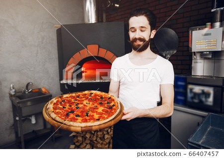 Chef in the kitchen prepares pizza Chef in the kitchen prepares pizza 66407457