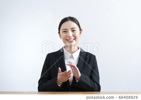 Young woman in a suit talking from the camera Young woman in a suit talking from the camera 66408929