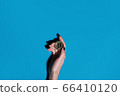 Woman holding golden bitcoin in her hand 66410120