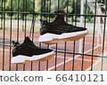 Black woman sneakers on a sportsground with sun 66410121