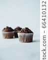 Beautiful chocolate muffins with pieces of chocolate 66410132