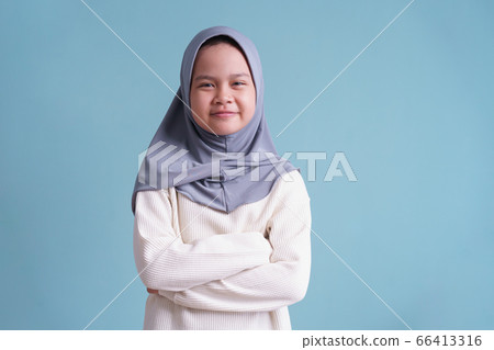Portrait of Happy Muslim little girl smile and looking to camera on blue background  isolated 66413316