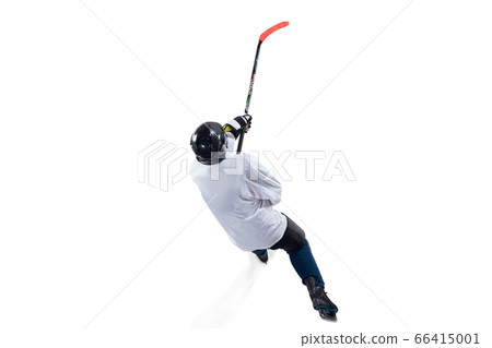 Unrecognizable male hockey player with the stick on ice court and white background Unrecognizable male hockey player with the stick on ice court and white background 66415001
