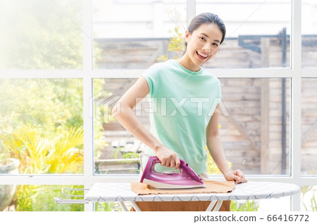Young housewife woman ironing housework person material Young housewife woman ironing housework person material 66416772