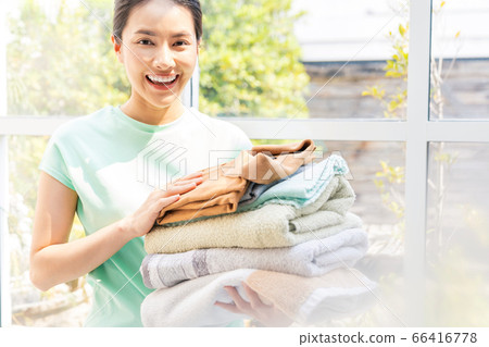 Young housewife housework laundry basket full person material Young housewife housework laundry basket full person material 66416778