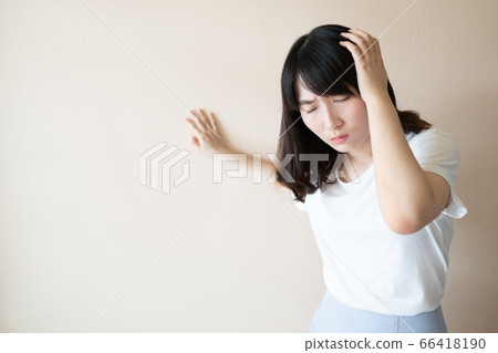 Young asian female suffering from dizziness, vertigo and headache over white background. Cause of dizzy included migraine, stress, stroke or brain tumor. Health care problem. 66418190