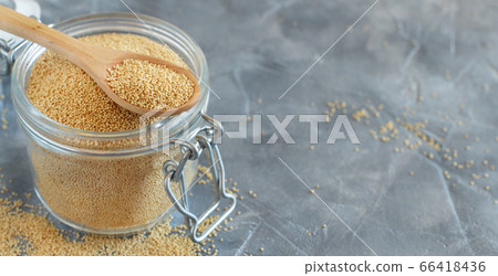 Jar of raw Amaranth seeds with a spoon Jar of raw Amaranth seeds with a spoon 66418436