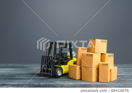 Yellow Forklift truck and cardboard boxes. Transportation logistics infrastructure, import and export goods and products delivery. Production, transport, cargo storage. Freight shipping. retail. 66418676