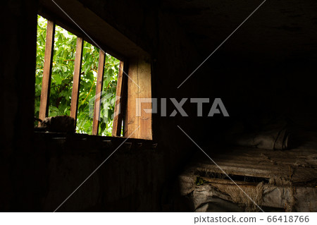 Light enters a dark barn through a small window in Light enters a dark barn through a small window in 66418766