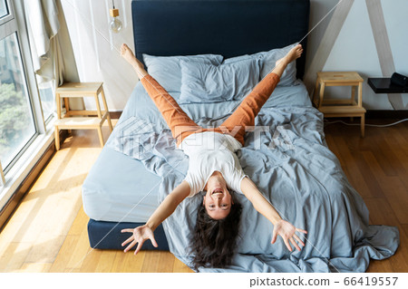 Beautiful young brunette girl fooling around on 66419557