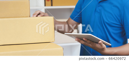 The shipping company checking parcels list before 66420972