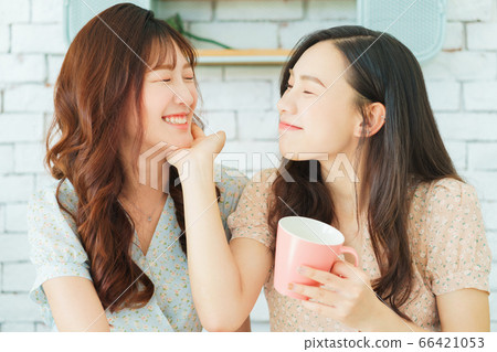 Two woman doing exercise at home Two woman doing exercise at home 66421053