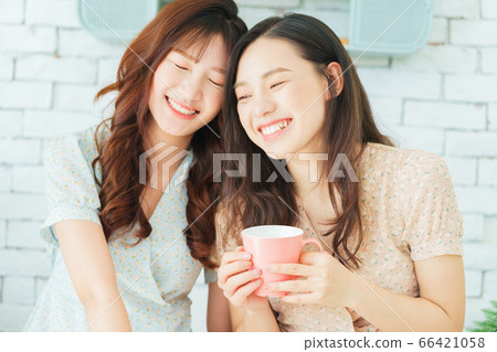Two woman doing exercise at home Two woman doing exercise at home 66421058