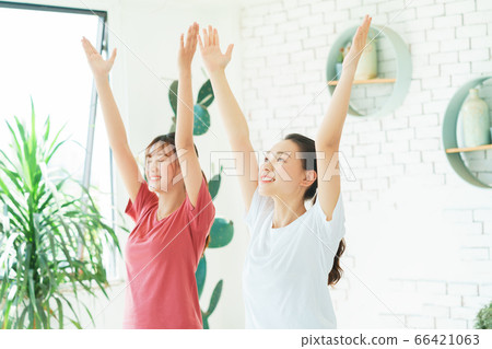 Two woman doing exercise at home 66421063