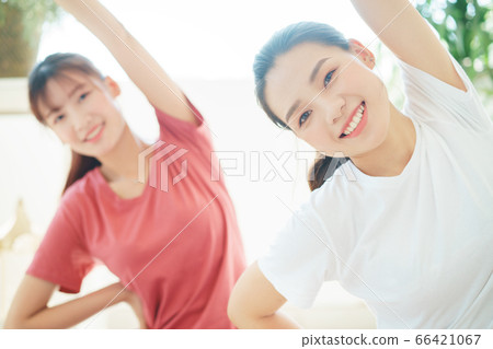 Two woman doing exercise at home 66421067