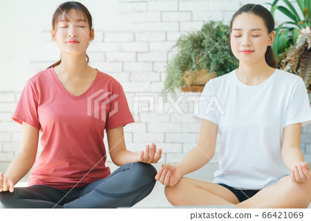 Two woman doing exercise at home 66421069