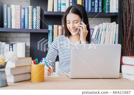 Young pretty woman library work cell phone talking person material 66421987
