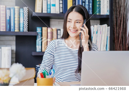 Young pretty woman library work cell phone talking person material 66421988