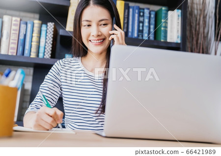 Young pretty woman library work cell phone talking person material 66421989