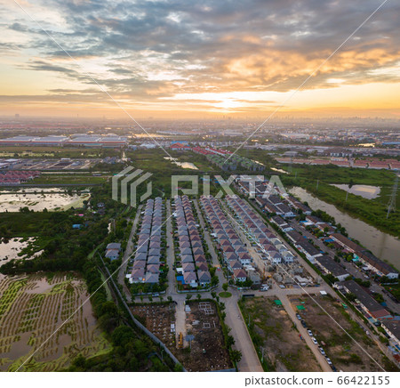 Sunset over city and field Sunset over city and field 66422155