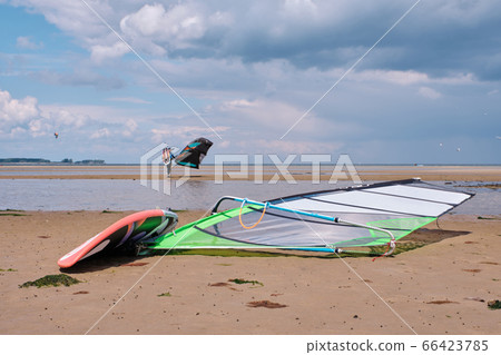 windsurfer board with kitesurfing in the background 66423785