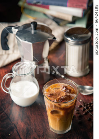 iced coffe with milk and book cafe background 66424198