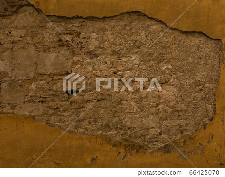 Old brick or stone wall with fallen stucco. Grunge texture of antique architecture. Abstract frame or background 66425070