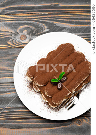 Classic tiramisu dessert on ceramic plate on wooden background Classic tiramisu dessert on ceramic plate on wooden background 66425590
