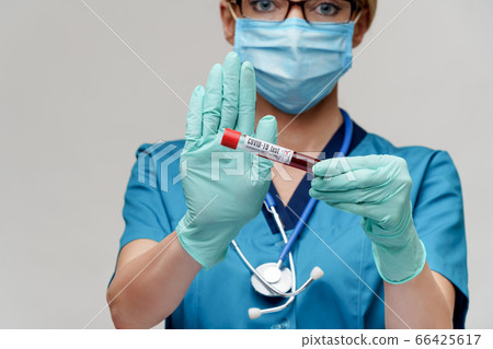 medical doctor nurse woman wearing protective mask and gloves - holding virus blood test tube medical doctor nurse woman wearing protective mask and gloves - holding virus blood test tube 66425617