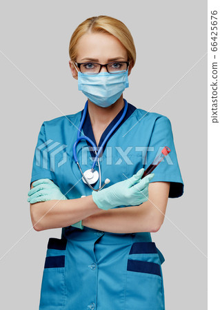 medical doctor nurse woman wearing protective mask and gloves - holding virus blood test tube medical doctor nurse woman wearing protective mask and gloves - holding virus blood test tube 66425676