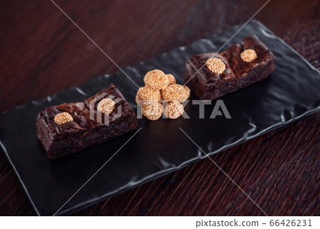 Chocolate brownies with sesame balls or Klepon, Kelepon, Onde Onde- traditional Southeast Asian rice cake balls. Asian modern dessert 66426231