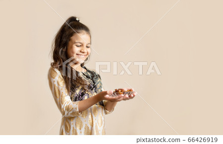 Small girl wearing traditional pakistani dress and 66426919