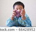 Infant playing clay 66428952
