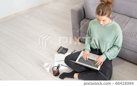 Young student learns at home on the floor Young student learns at home on the floor 66428994