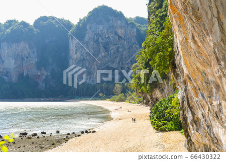 Tonsai Beach in low season (July). An almost empty strip of sand, steep cliffs, and jungles. Ton Sai is a more secluded and budget location of famous Railay Peninsula. Traveling in Krabi, Thailand. 66430322