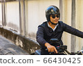 Handsome motorcyclist and his motorcycle. Handsome motorcyclist and his motorcycle. 66430425