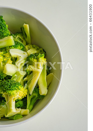 Vertical overhead view photo of cooked broccoli in white bowl Vertical overhead view photo of cooked broccoli in white bowl 66431900