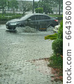 Car on the flood road of thailand 66436800