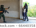 Soldier is rescuing Asian hostage. Soldier is rescuing Asian hostage. 66440358