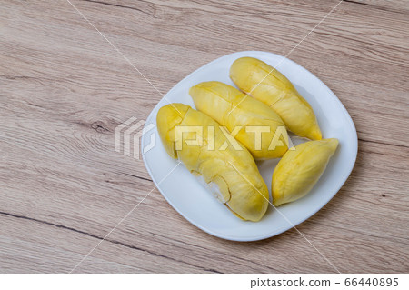 Fresh durian fruit placed on a white plate. Fresh durian fruit placed on a white plate. 66440895