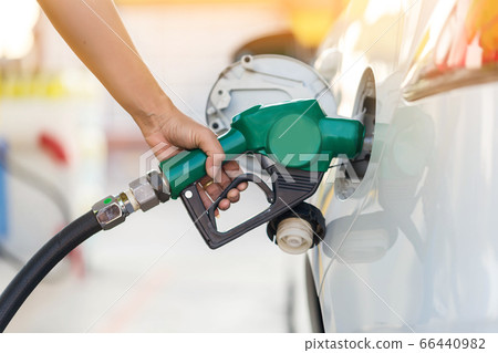 Man Refill and filling Oil Gas Fuel at station. 66440982