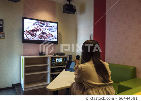 Image material for a woman singing in a karaoke box 66444581