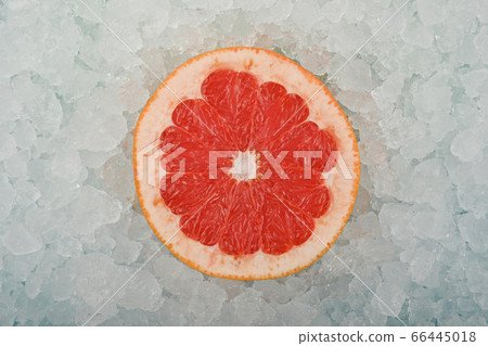 Fresh pink grapefruit slice over crushed ice Fresh pink grapefruit slice over crushed ice 66445018